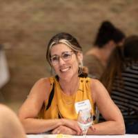 Educator smiles at GVSU Education Alumni Network teacher and mentor appreciation night